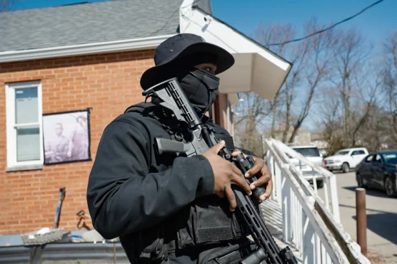 A member of Lincoln Heights' community-led patrol monitors the area outside a local center as part of the neighborhood’s grassroots safety effort. Photo: NBC News